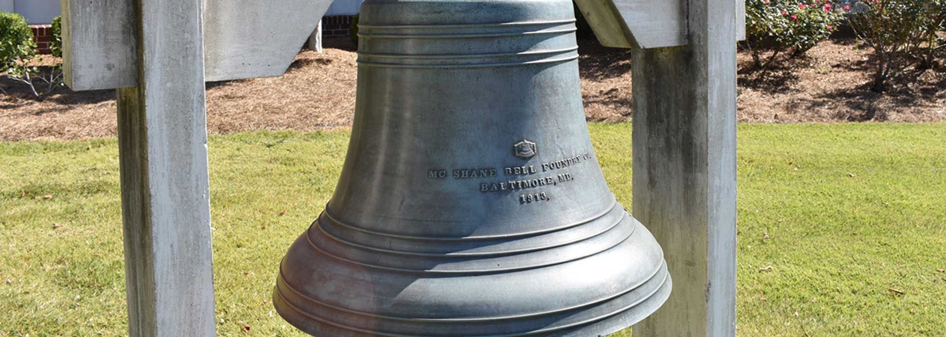 Old Courthouse Bell in front yard of courthouse facing highway 31 reads Mc Shave Bell Foundry Baltimore, MD 1913